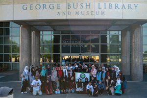 IASW students standing in front of the George BUsh Library and museum at U of H.